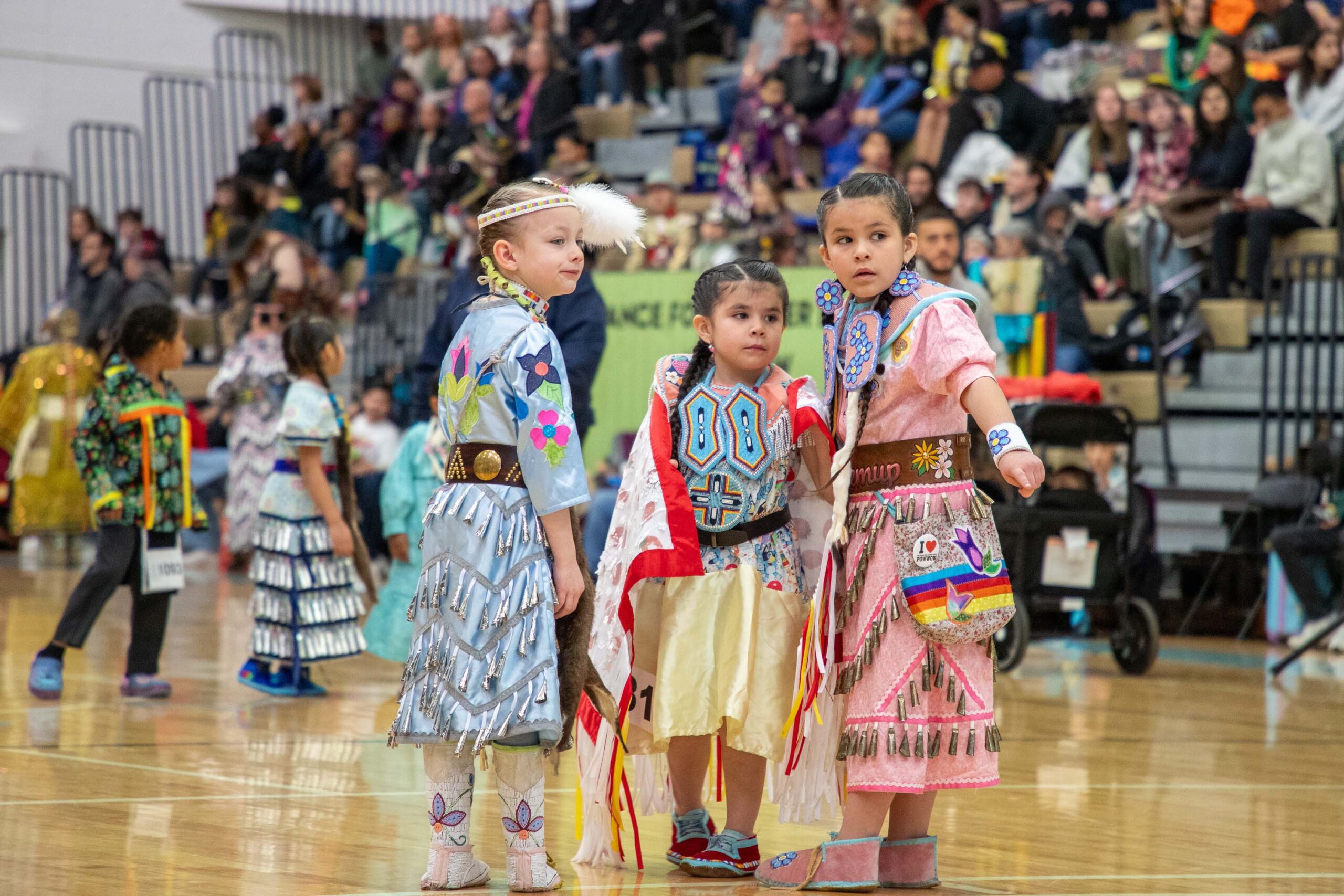 young girls in regalia talking